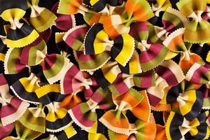 Mixed colorful farfalle pasta. Flat lay. Top view. photo