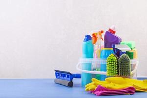 Cleaning service concept. Colorful cleaning set for different surfaces in kitchen, bathroom and other rooms. photo