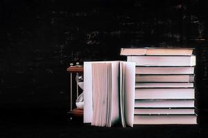 Stack of different books on dark background. Knowledge concept. photo