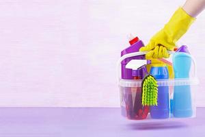 Cleaning service concept. Colorful cleaning set for different surfaces in kitchen, bathroom and other rooms. photo