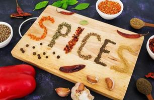 Different spices on dark background photo