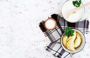 Delicious dumplings with cabbage on white background. Top view photo