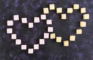 Heart of marshmallow on dark background. Top view photo