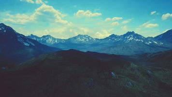 Mountain gorge with green meadow illuminated by the sun video