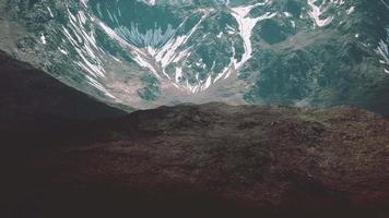 Mountain gorge with green meadow illuminated by the sun video