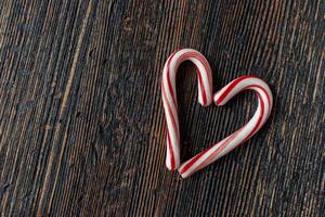 candy cane heart with copy space on rustic wood table flat lay photo