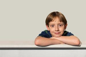 smiling happy young boy with brown eyes on frame edge with copy space photo