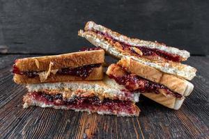 messy peanut butter and jelly sandwiches cut in half in stack photo