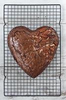 brownie en forma de corazón con nueces en un lado sobre una rejilla para hornear plana foto