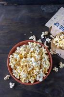 popped bag popcorn torn open and spilling out flat lay photo