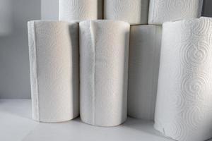 stocking up on supplies with stack of white paper towels on white background photo