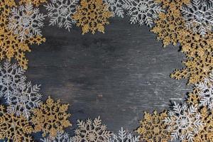 Christmas border background of gold and silver snowflakes flat lay photo