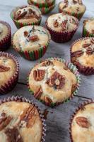 group of baked blueberry muffins topped with pecans
