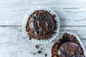 Fudge chocolate brownie cupcakes on rustic light background photo