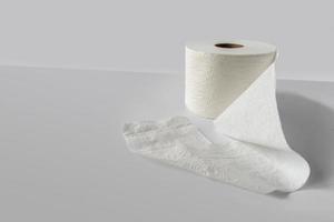 single roll of white toilet paper on white background with copy space photo