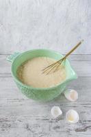 Ingredients for baking a cake with egg yolks in a bright bowl photo