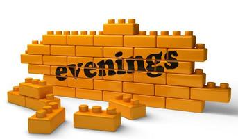 evenings word on yellow brick wall photo