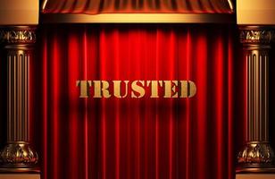 trusted golden word on red curtain
