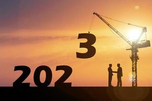 Happy New Year 2023 concept. Businessmen join hands. Successful in contacting work photo