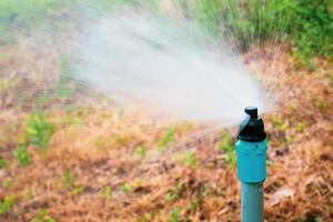 Close-up shot of a spray nozzle in an agricultural field. photo