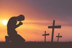 Silhouette of Christian Praying Hands Spiritual and Religious People Praying to God Christianity Concepts. End war and violence photo