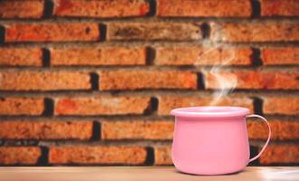 A bright pink metallic coffee cup on vacation. photo