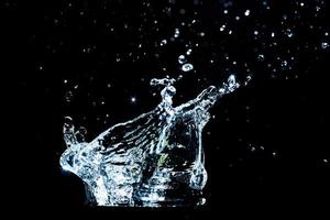 Scattered water splashes on a black background. water splash isolated on the black background photo