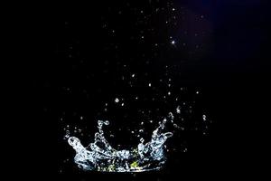 Scattered water splashes on a black background. water splash isolated on the black background photo