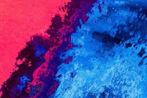 Bright pink and blue hand-painted acrylic pouring surface. Abstract wet fluid marbling background texture photo