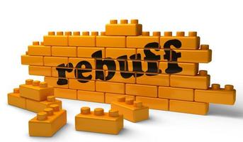 rebuff word on yellow brick wall photo