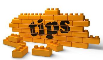 tips word on yellow brick wall photo