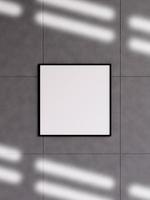 Modern and minimalist square black poster or photo frame mockup on the concrete wall in a room. 3d rendering.