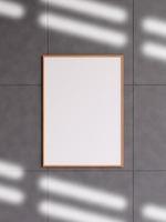 Modern and minimalist vertical wooden poster or photo frame mockup on the concrete wall in a room. 3d rendering.