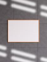 Modern and minimalist horizontal wooden poster or photo frame mockup on the concrete wall in a room. 3d rendering.
