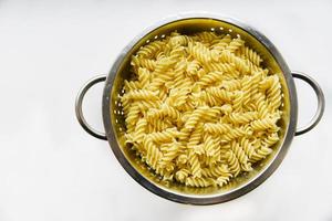 Boiled vermicelli noodles horns in a colander photo