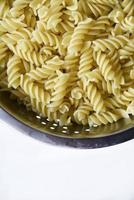 Boiled vermicelli noodles horns in a colander photo