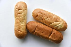 Three hot dog buns on a plate photo