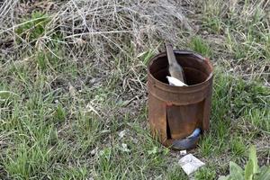 Garbage and household waste on the riverbank from vacationers. Environmental pollution. photo