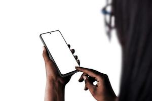 Phone mockup in woman hand, dark skin, low light isolated. Over shoulder view photo