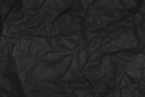 black crumpled paper texture as background photo