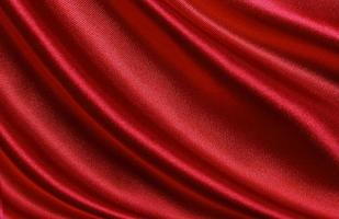 Red silk or satin luxury fabric texture can use as abstract background. Top view photo
