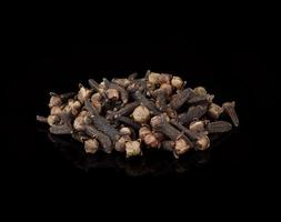 dried cloves isolated on black  background photo