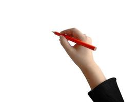 mano femenina aislada que sostiene la escritura con lápiz de color naranja, para el elemento de presentación foto