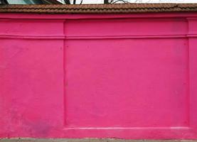 Shocking pink color paint on plaster wall photo