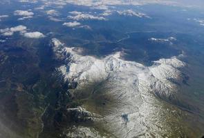 Alps mountain covered by white snow view from airplane photo