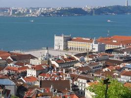 A top view of big plaza and red roof buildings near Tagus river of lisbon portugal photo