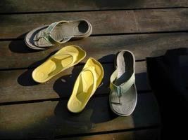 two pairs of sandal yellow and green represent of relationship close and love photo