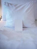 Blank greetings card on the bed with turn down service photo