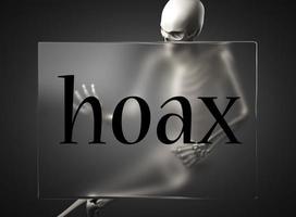 hoax word on glass and skeleton photo