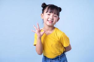 Image of Asian child posing on blue background photo